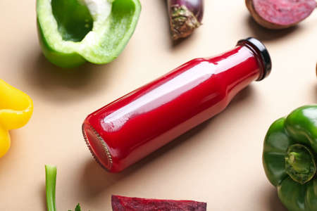 Bottle of healthy smoothie and different vegetables on color background, closeupの写真素材