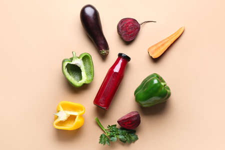 Composition with bottle of smoothie and different vegetables on color backgroundの写真素材