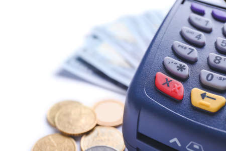 Payment terminal with money on white background, closeupの写真素材
