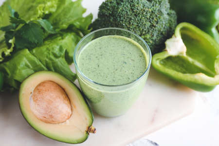 Glass of healthy smoothie with vegetables on light background, closeupの写真素材