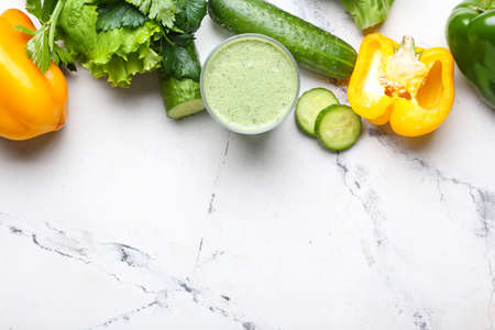 Glass of healthy smoothie with vegetables on light backgroundの写真素材