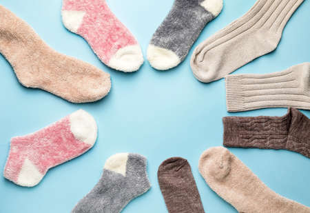 Frame made of warm socks on color backgroundの写真素材