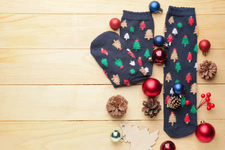 Warm socks and Christmas decor on wooden backgroundの写真素材