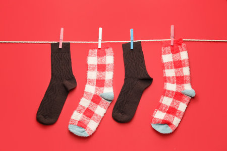 Rope with warm socks on color backgroundの写真素材