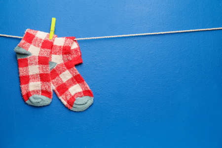 Rope with warm socks on color backgroundの写真素材