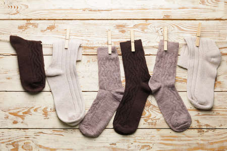 Rope with warm socks on wooden backgroundの写真素材