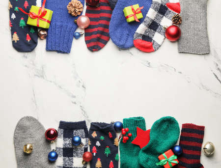 Warm socks and Christmas decor on light backgroundの写真素材