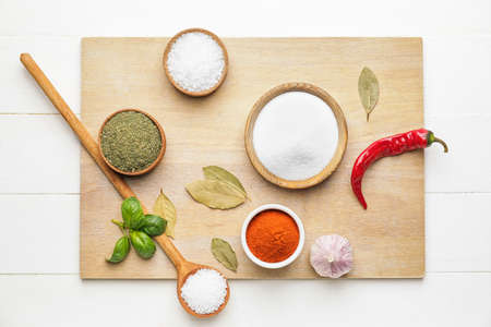 Composition with different spices on light wooden backgroundの写真素材