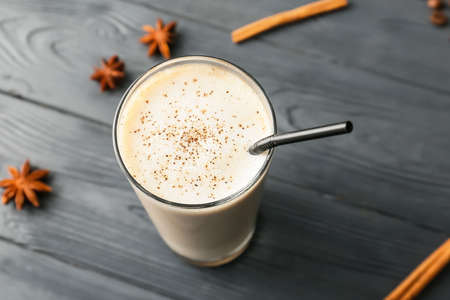 Glass of tasty latte on dark wooden backgroundの写真素材