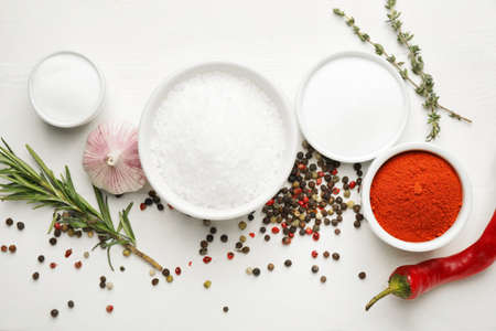 Composition with different spices and herbs on light wooden backgroundの写真素材