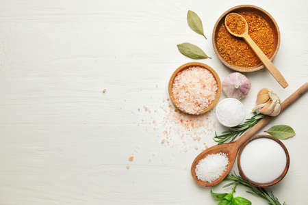 Composition with different spices and herbs on light wooden backgroundの写真素材