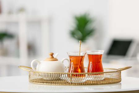 Tray with cups of hot tea on tableの写真素材
