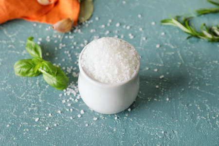 Bowl with salt on color backgroundの写真素材