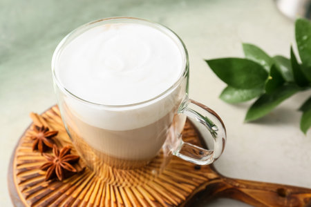 Glass cup of tasty latte on light backgroundの写真素材