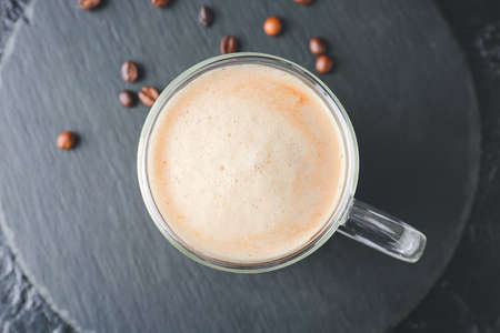 Glass cup of tasty latte on dark backgroundの写真素材