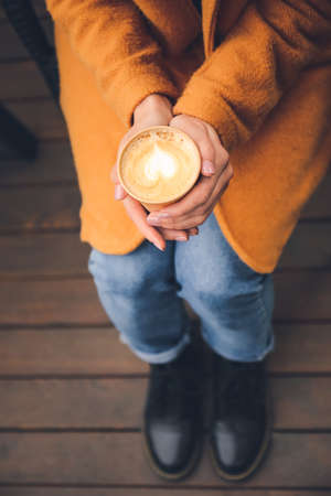 Woman with takeaway cup of tasty latte outdoors