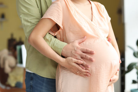 Young pregnant couple at home