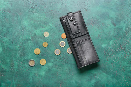 Wallet with coins on color background. Concept of bankruptcyの写真素材