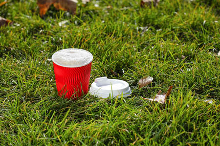 Takeaway cup of tasty latte on grassの写真素材