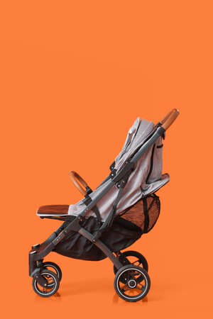 Modern baby stroller on color backgroundの写真素材