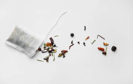 Tea bag with dry leaves on white backgroundの写真素材