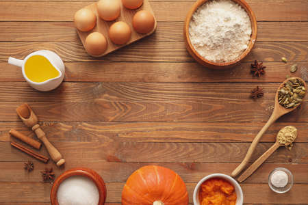 Ingredients for preparing pumpkin pie on wooden backgroundの写真素材