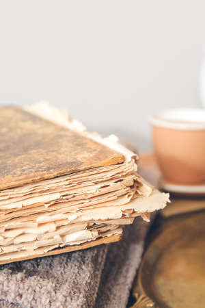Old book and plaid on table, closeup