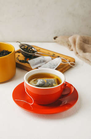 Cup with tea bag on light backgroundの写真素材