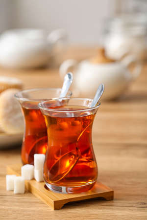 Cups of hot Turkish tea on wooden tableの写真素材