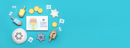 Different symbols of Hanukkah and greeting card on color background with space for textの写真素材