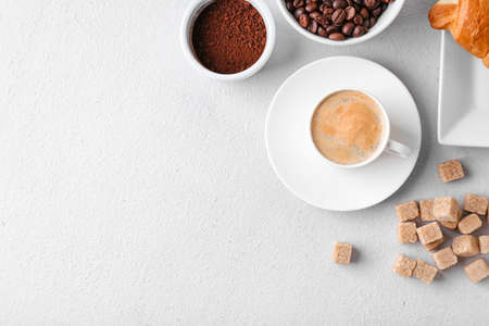 Composition with cup of hot coffee on light backgroundの写真素材