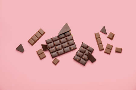 Composition with different chocolate on color background