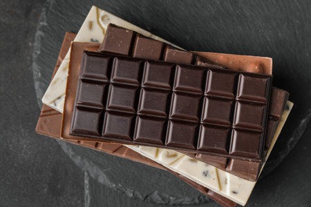 Different chocolate bars on dark background