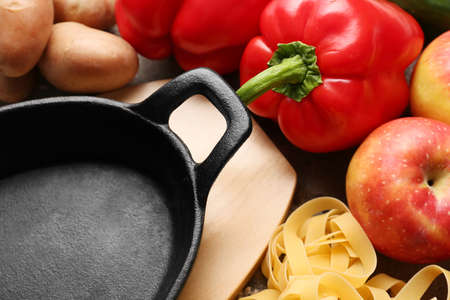 Clean frying pan with products on tableの写真素材