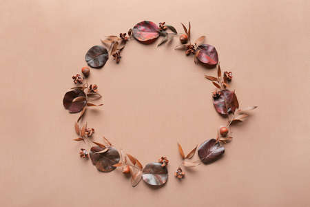 Frame made of autumn leaves on color backgroundの写真素材