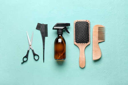 Set of hairdresser's tools on color background