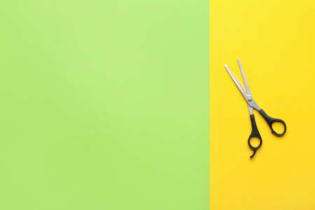 Professional hairdresser's scissors on colorful backgroundの写真素材
