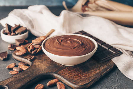 Bowl of tasty melted chocolate on dark backgroundの写真素材
