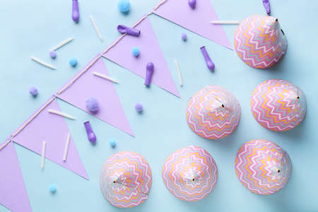 Composition with party hats on color background