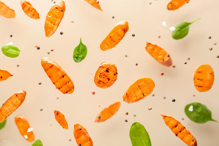 Tasty grilled carrot on color backgroundの写真素材