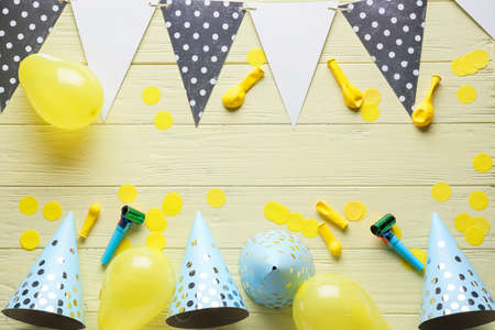 Composition with party hats on color wooden backgroundの写真素材