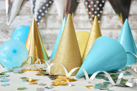 Composition with party hats on light background