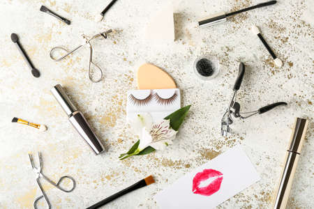 Composition with false eyelashes, mascara and tools on grunge backgroundの写真素材
