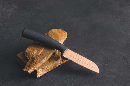 Knife with sharpening stones on dark background