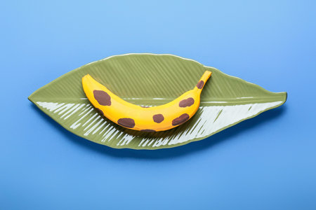 Plate with painted banana on color backgroundの写真素材