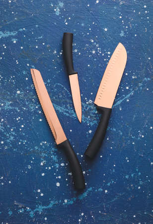 Set of knives on color background