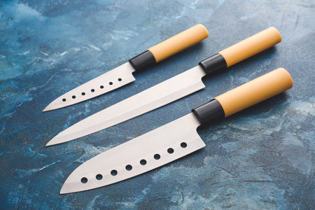 Set of knives on color background