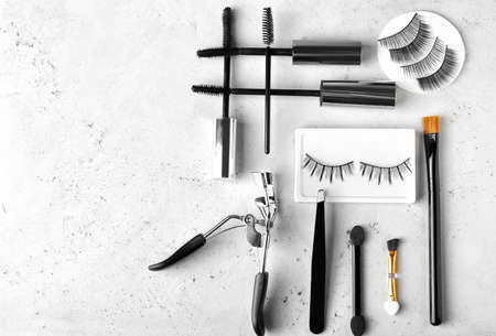 Composition with false eyelashes, mascara and tools on light backgroundの写真素材