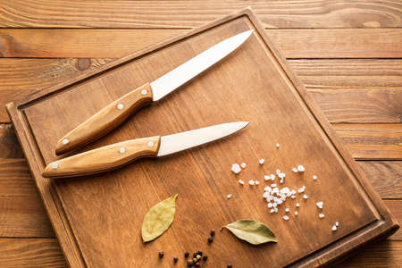 Knives with spices on wooden backgroundの写真素材