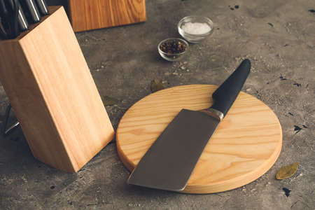 Set of knives in wooden stand on grunge backgroundの写真素材